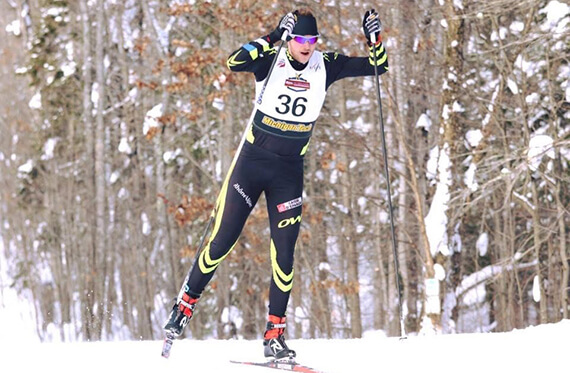 Action shot of Tom outside cross-country skiing in a black outfit